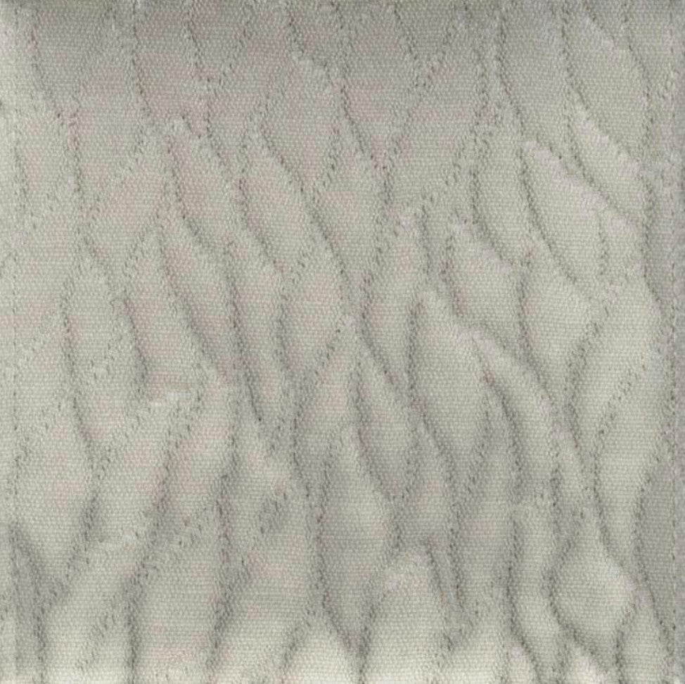 quilted leaf fabric detail showing dimensional texture in grey