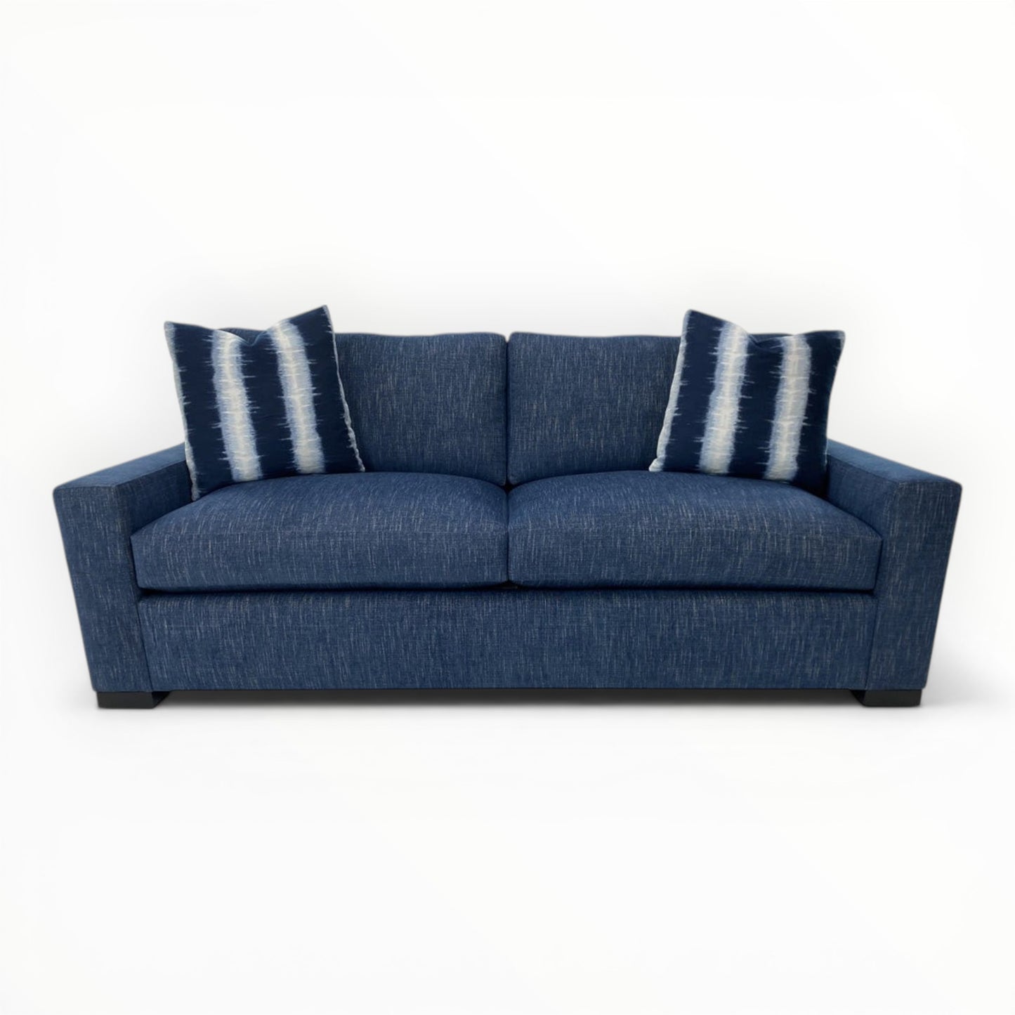 Morgan Banda Indigo throw pillows shown on modern sofa