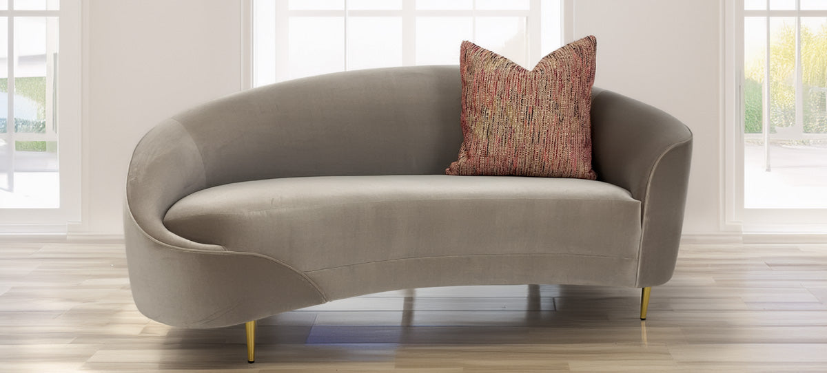 Nobilis Rue Cambon throw pillow shown on modern curved sofa