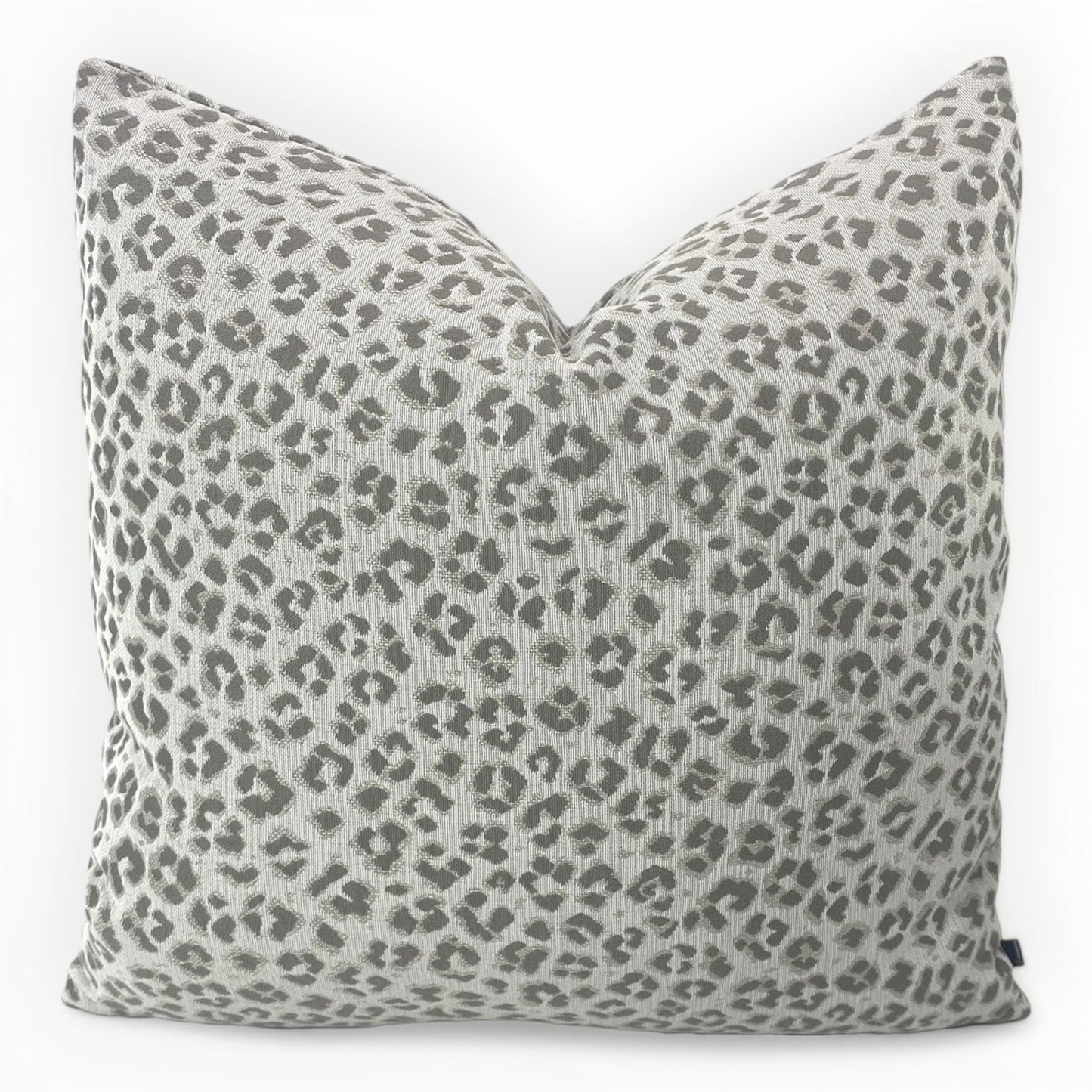 designer leopard print throw pillow cover in taupe on neutral sofa