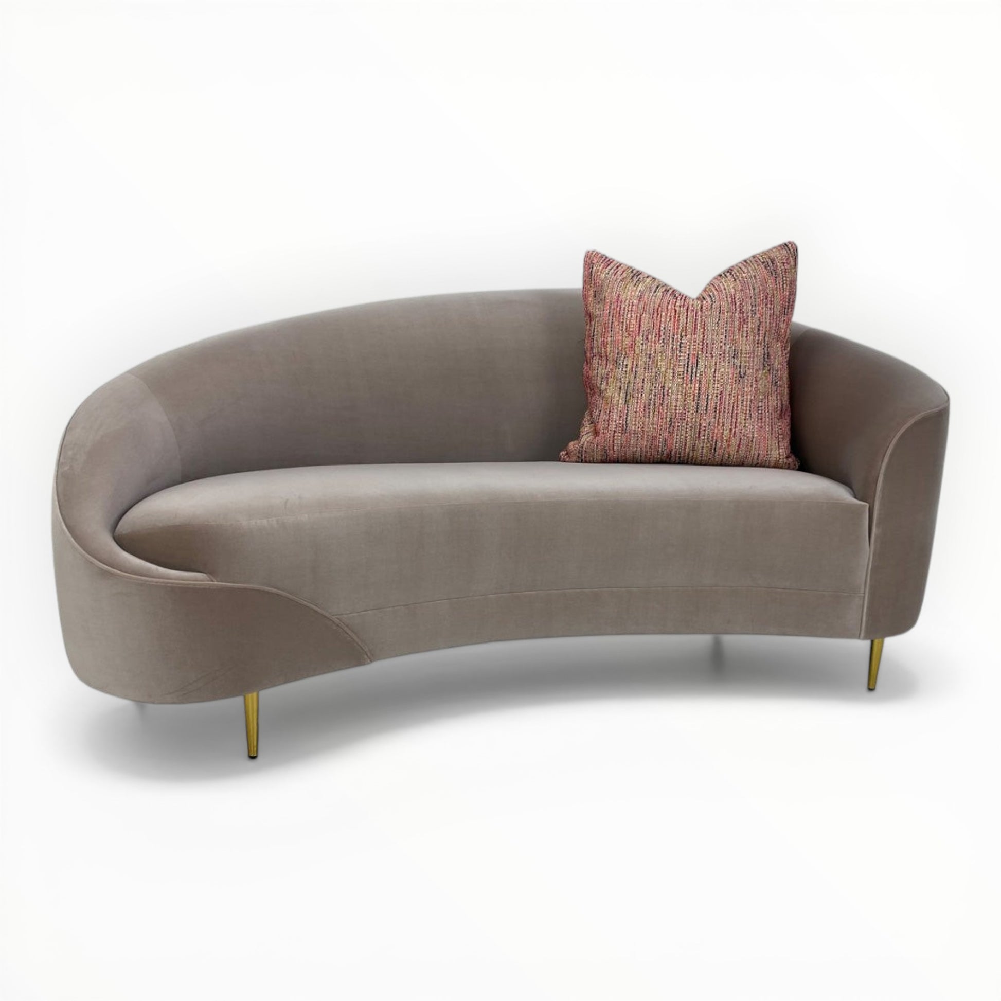 Nobilis Rue Cambon throw pillows shown on modern curved sofa