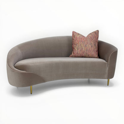 Nobilis Rue Cambon throw pillows shown on modern curved sofa
