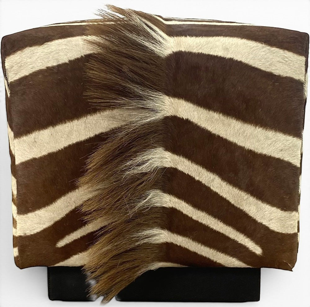Pillowfina vintage zebra hide cube ottoman with natural brown and cream stripes and textured mane detail.