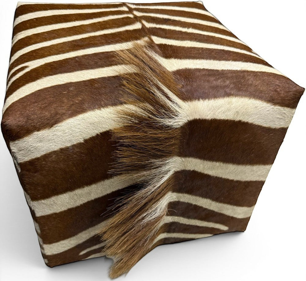 Pillowfina vintage zebra hide cube ottoman with natural brown and cream striped fur texture and central mane detail.